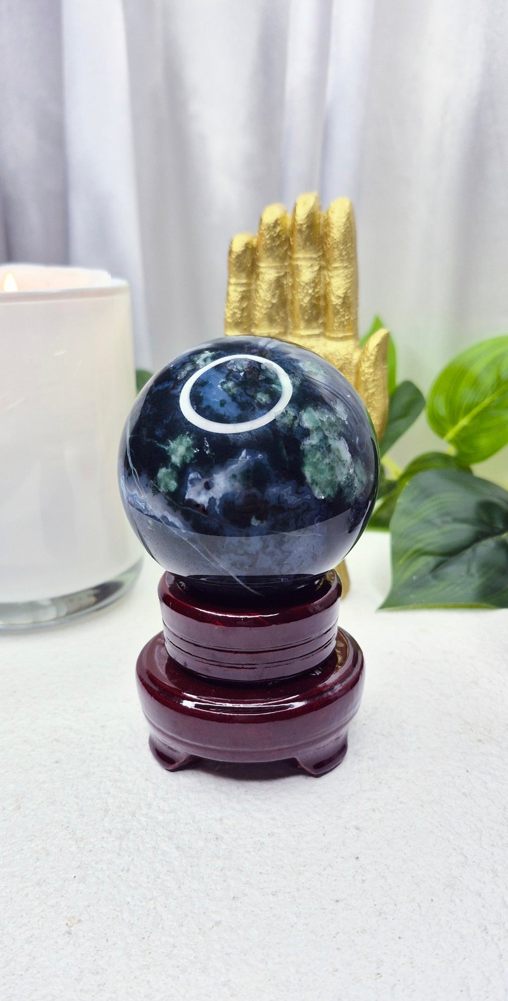 Moss Agate Sphere on wooden Stand