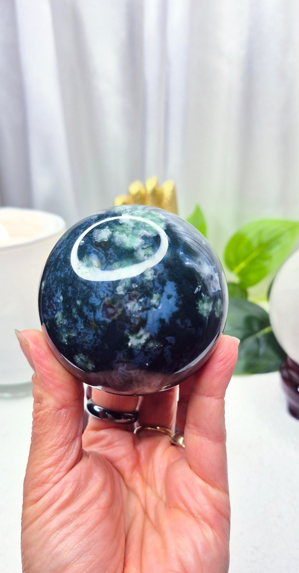 Moss Agate Sphere on wooden Stand