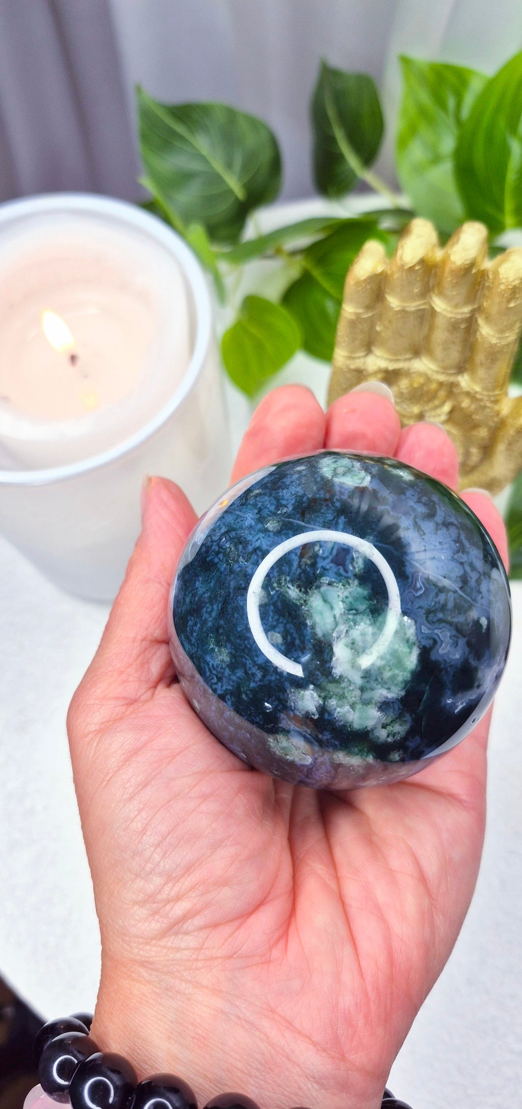 Moss Agate Sphere on wooden Stand