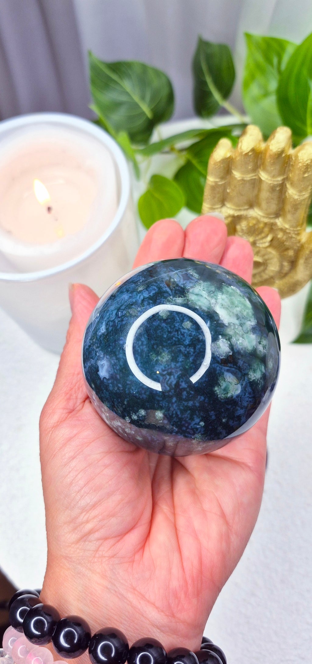 Moss Agate Sphere on wooden Stand
