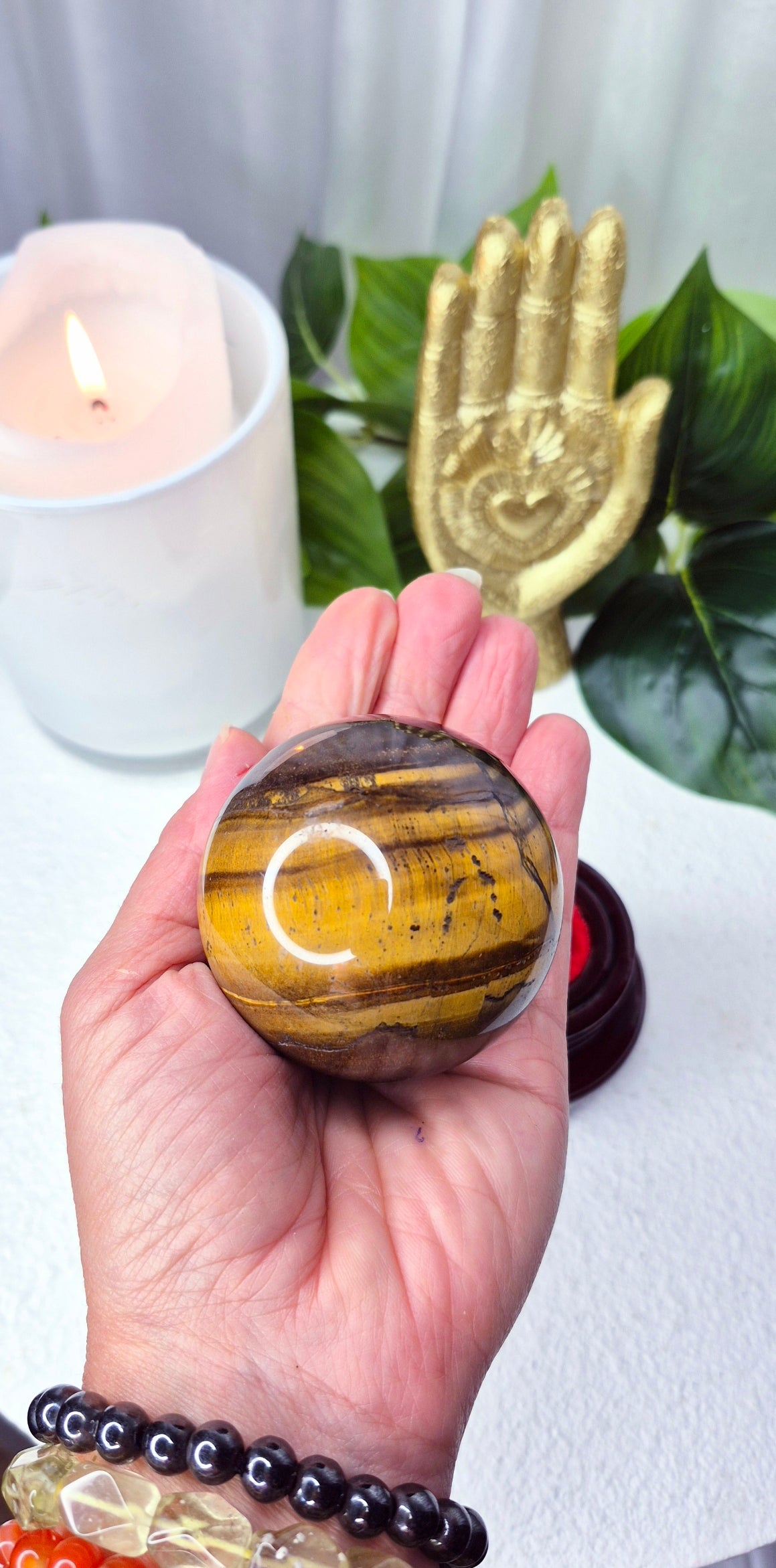 Tigers Eye Sphere on wooden Stand